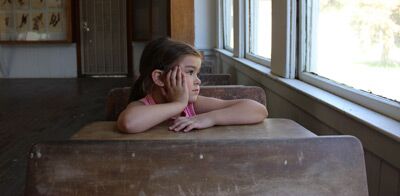 Little girl looking out of the school window