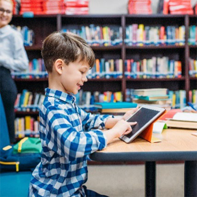 Young boy touching tablet computer